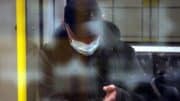 Mann - U-Bahn - Straßenbahn - Smartphone - Kopfhörer - Schutzmaske - Öffentlichkeit